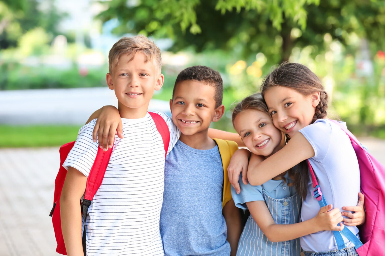 A group of kids in front of a building, displaying the bonding and affection synonymous with the Gemini sign.