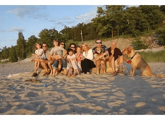 A group of people sitting together on the beach