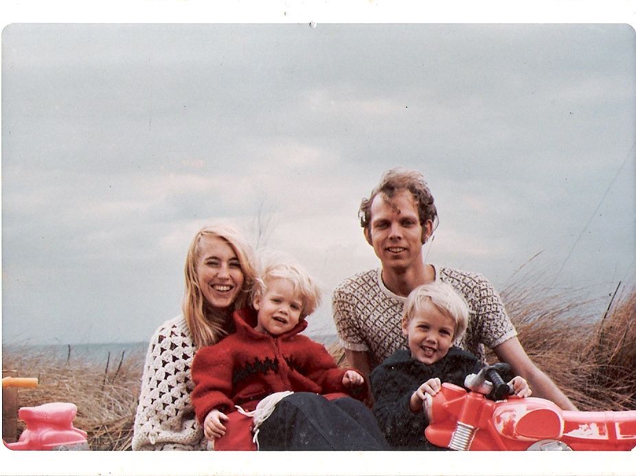 A family of four sitting together and smiling